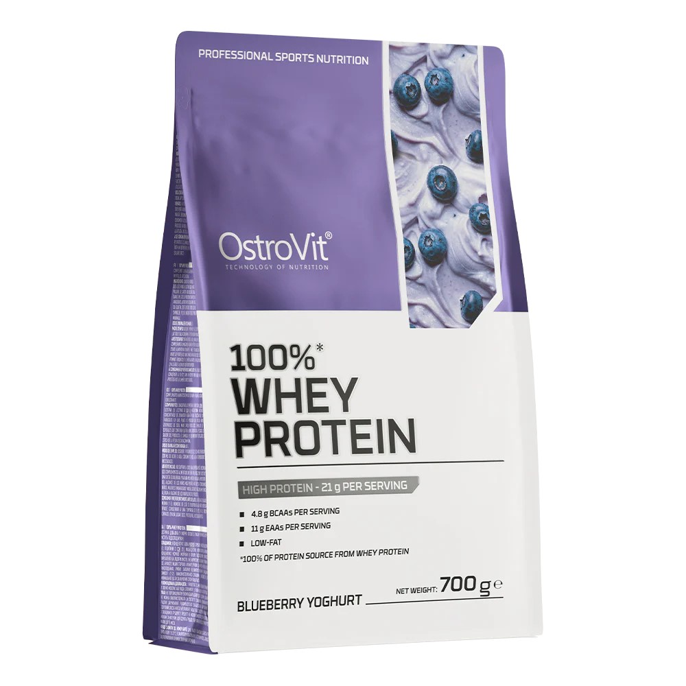 OstroVit 100% Whey Protein blueberry yoghurt flavour, 700g pouch, high protein supplement with BCAAs and EAAs, low-fat, purple and white packaging.