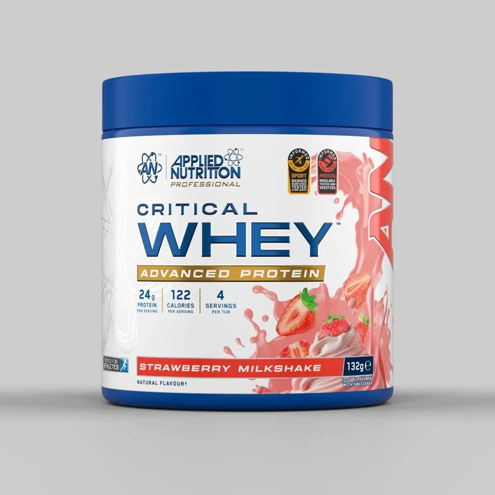 Applied Nutrition Critical Whey 4 Servings pouch beside a clear shaker bottle filled with mixed protein shake