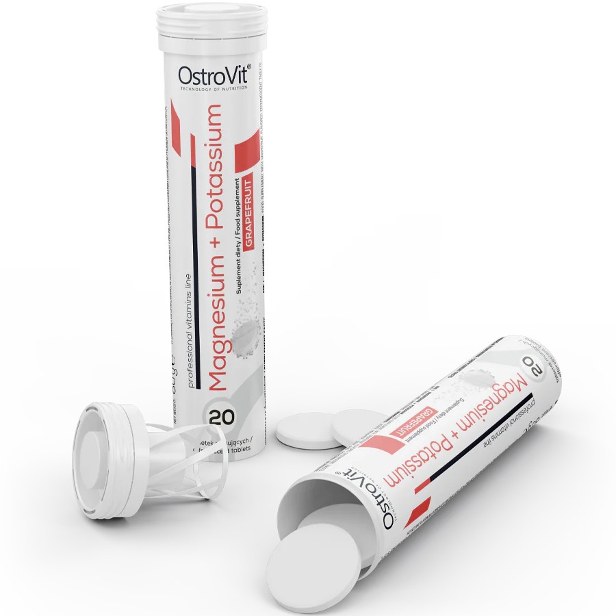 OstroVit Magnesium + Potassium 20 effervescent tablets in grapefruit flavour, dietary supplement in a white tube with red accents, tablets visible outside the packaging.